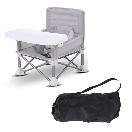 Folded Mini Majesty toddler camping chair being carried with ease, showing its lightweight, portable design.
